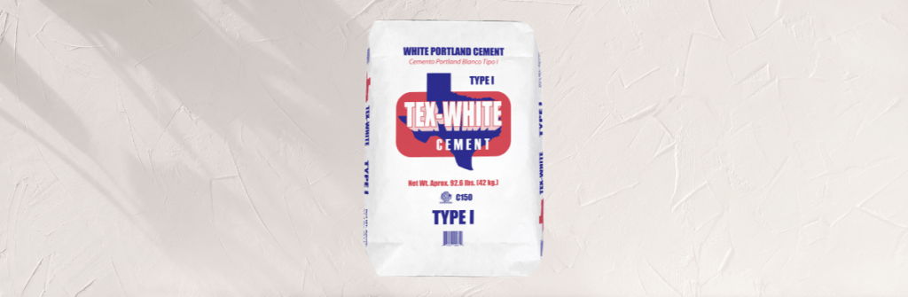 A bag of white Portland cement atop a white plaster wall background
