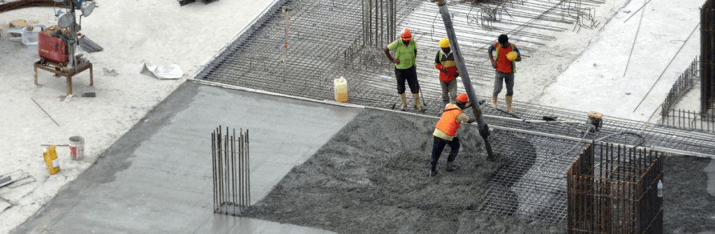 Construction crew pouring cement at a job site