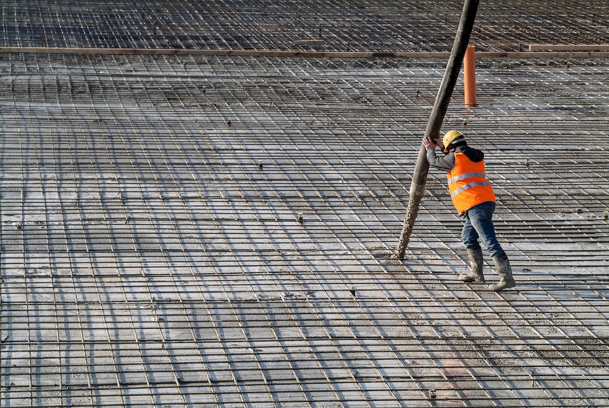 Construction worker at a construction site using cement