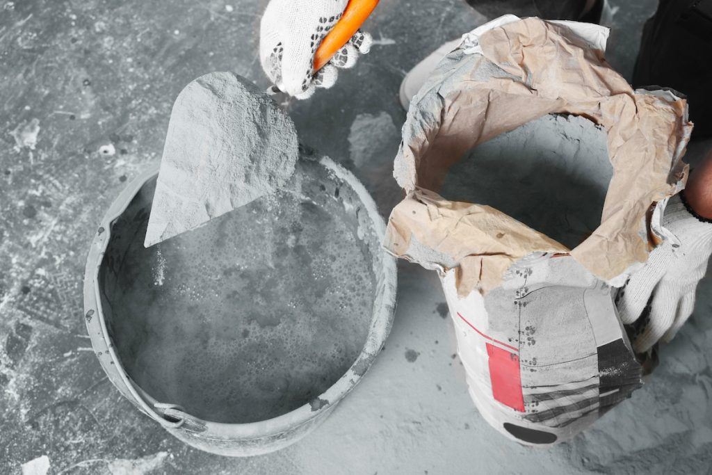 A bag of masonry cement being mixed at the job site