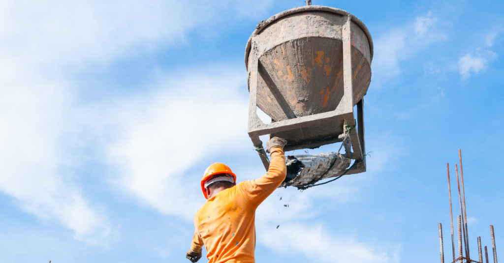 Cement worker pulling down the end of a cement dispenser