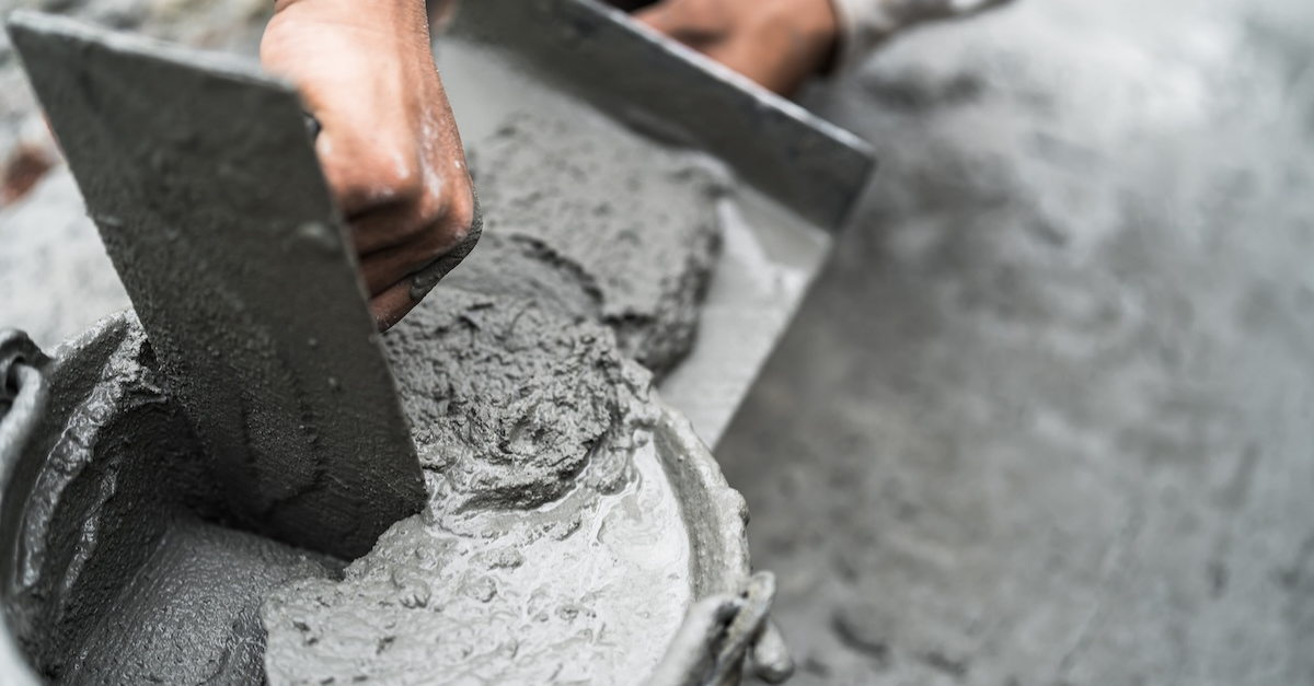 Worker mixing Portland Cement at the job site